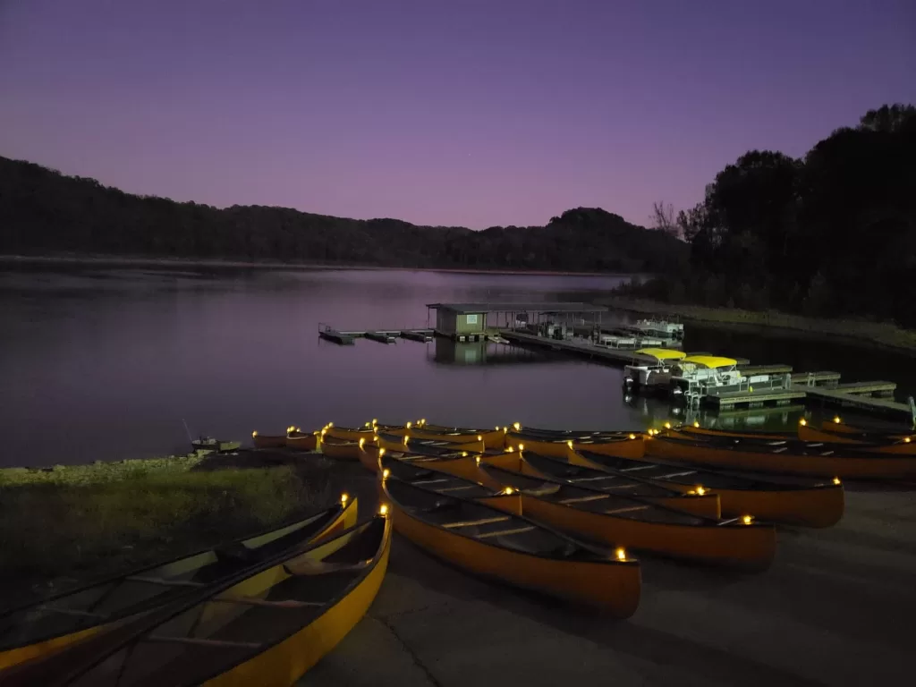 canoes lined up on the shore at night for the haunted canoe trip
