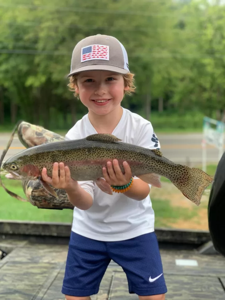 kid with rainbow trout